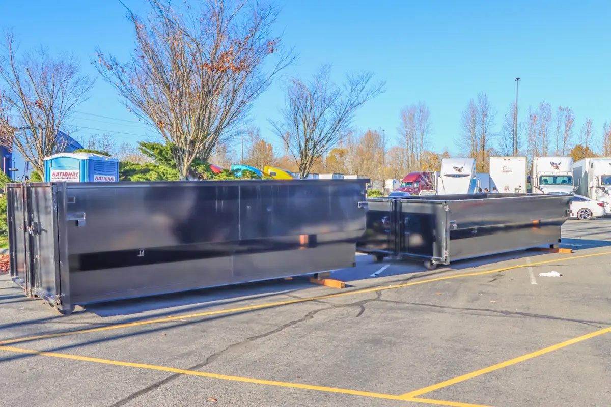 Professional dumpster rental service with roll-off container on residential driveway in Maryland City